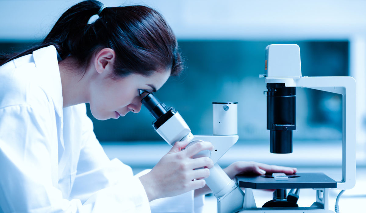 Scientist using a microscope